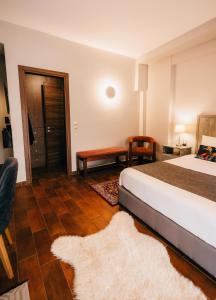 a bedroom with a bed and a table and a chair at MARON in Kalavrita +84 photos