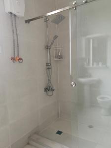 a shower with a glass door in a bathroom at Hostel Rioni in Kutaisi +14 photos