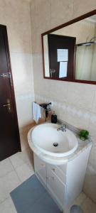 a bathroom with a white sink and a mirror at TurisMar Vila do Conde in Macieiro da Maia +29 photos