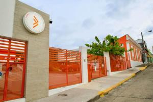 a building with a clock on the side of it at 1.1• Disabled • Generator • 1st Floor • Parking in Mayaguez