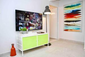 a living room with a tv on a wall at 1.1• Disabled • Generator • 1st Floor • Parking in Mayaguez