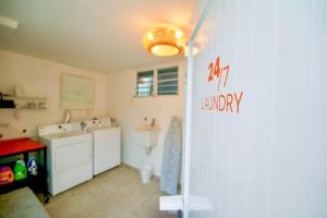 a bathroom with a sink and a washing machine at 1.1• Disabled • Generator • 1st Floor • Parking in Mayaguez