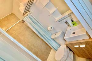 an overhead view of a bathroom with a toilet and a shower at 1.7 • Balcony • Generator • Parking • 2nd Floor in Mayaguez