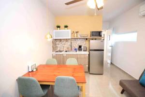 a kitchen with a wooden table and a refrigerator at 1.7 • Balcony • Generator • Parking • 2nd Floor in Mayaguez