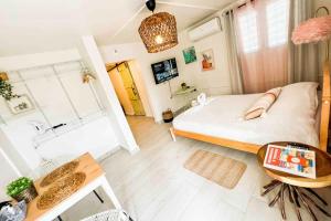 a small bedroom with a bed and a table at 3.1 Near Beach • Generator • Hammock • 1BR in Garita