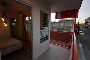 a room with a balcony with a view of a street at 1.6 • Balcony • Generator • Parking • 2nd Floor in Mayaguez