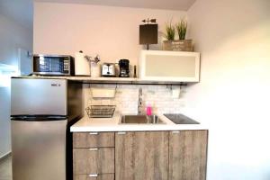 a kitchen with a sink and a refrigerator at 1.6 • Balcony • Generator • Parking • 2nd Floor in Mayaguez