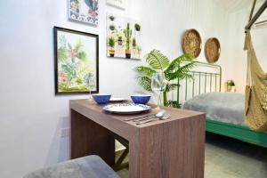 a room with a wooden table with a bed at 1.4 • Generator • 1st Floor • Parking • 238sf in Mayaguez