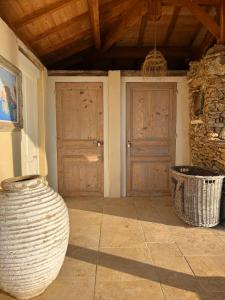a room with two wooden doors and two baskets at Châtel de Bierre in Sigy-le-Châtel +73 photos