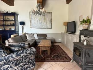 a living room with a couch and a table at Châtel de Bierre in Sigy-le-Châtel