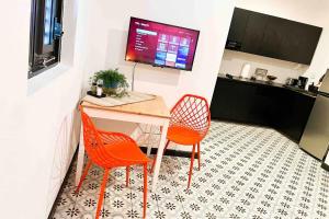 a room with two chairs and a desk and a television at 5.4 Loft • Lobby • Generator • Parking • 2nd Floor in Mayaguez