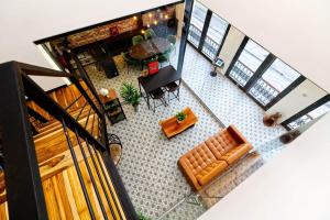 an overhead view of a living room with a couch and a table at 5.4 Loft • Lobby • Generator • Parking • 2nd Floor in Mayaguez +35 photos