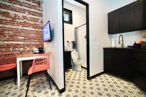 a bathroom with a red chair and a mirror at 5.1 Loft • Lobby • Generator • Parking • 2nd Floor in Mayaguez