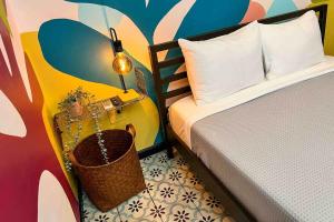 a bedroom with a bed and a table with a basket at 5.6 Loft • Lobby • Generator • Parking • 2nd Floor in Mayaguez