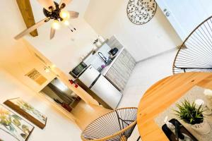 a living room with a table and chairs and a clock at 3.6 Near Beach • Generator • Hammock • 2nd floor in Garita