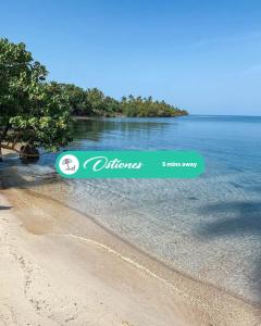 a sign on a beach with an island in the water at 3.6 Near Beach • Generator • Hammock • 2nd floor in Garita