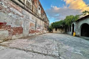 an old brick building with a street next to it at 5.2 Loft • Lobby • Generator • Parking • 2nd Floor in Mayaguez +44 photos