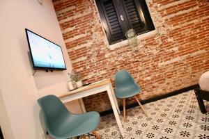 a living room with two chairs and a television at 5.3 Loft • Lobby • Generator • Parking • 2nd Floor in Mayaguez +53 photos