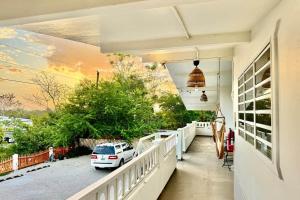 a white car parked on the porch of a house at 3.7 Near Beach • Generator • Hammock • 2nd floor in Garita