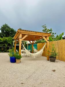 a wooden gazebo with a hammock and a fence at 3.7 Near Beach • Generator • Hammock • 2nd floor in Garita