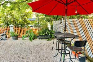 a table and chairs with a red umbrella at 3.7 Near Beach • Generator • Hammock • 2nd floor in Garita +45 photos
