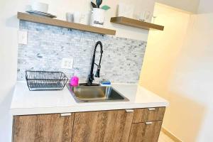 a kitchen with a sink and a brick wall at 3.8 Near Beach • Generator • Hammock • 2nd floor in Garita