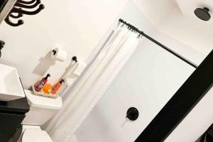 a bathroom with white walls and a white shower curtain at 5.5 Loft • Lobby • Generator • Parking • 2nd Floor in Mayaguez