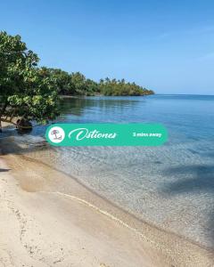 a sign on a beach next to a body of water at 3.8 Near Beach • Generator • Hammock • 2nd floor in Garita