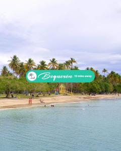 a sign on a beach with people in the water at 3.9 Near Beach • Generator • Hammock • 1st Floor in Garita +42 photos