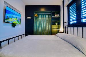 a bedroom with a large bed and a flat screen tv at 5.7 Penthouse • Generator • Parking • 3rd floor in Mayaguez