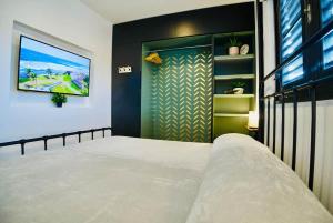 a bedroom with a large bed and a flat screen tv at 5.7 Penthouse • Generator • Parking • 3rd floor in Mayaguez