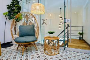 a room with a rattan chair and a table at 5.7 Penthouse • Generator • Parking • 3rd floor in Mayaguez