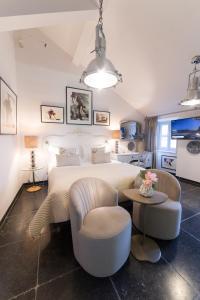 a bedroom with a bed and a table and chairs at Prijeko Palace in Dubrovnik