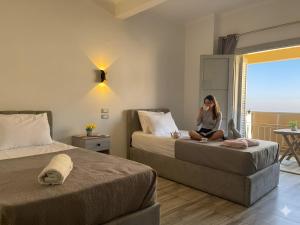 a woman sitting on a bed in a hotel room at Park Plaza Haven in Cairo
