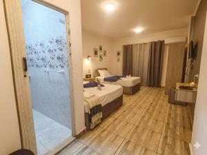 a hotel room with two beds and a sliding glass door at Park Plaza Haven in Cairo +26 photos