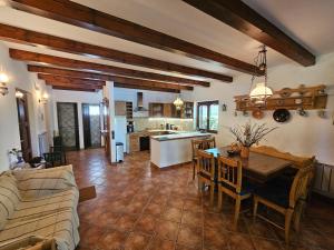 a living room with a couch and a table and a kitchen at Waterside Cottage in Nagyrév