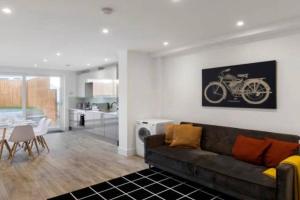 a living room with a couch and a kitchen at 3BD in Hendon in The Hyde