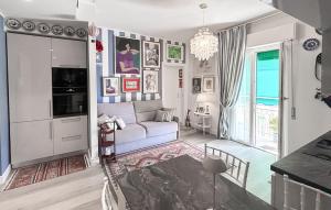 a living room with a couch and a chandelier at 2 Bedroom Awesome Apartment In Chiavari in Chiavari