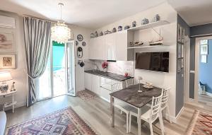 a kitchen with a table and a dining room at 2 Bedroom Awesome Apartment In Chiavari in Chiavari +11 photos