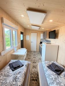 a small room with two beds and a kitchen at Tiny Stay Guesthouse - Würzburg in Würzburg