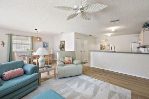 a living room with a couch and a ceiling fan at Patio Villa in Santo Domingo in The Villages