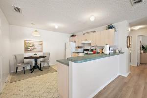 a kitchen with a counter and a table in a room at Patio Villa in Santo Domingo in The Villages