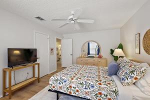 a bedroom with a bed and a flat screen tv at Patio Villa in Santo Domingo in The Villages +17 photos