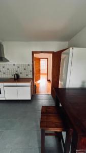 a kitchen with a refrigerator and a table in it at Die Ferienwohnung im Grünen in Lichtenau +6 photos