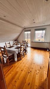 a large room with a bed and chairs in it at Die Ferienwohnung im Grünen in Lichtenau