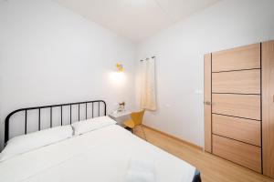a bedroom with a large bed and a wooden closet at Yoosabai Hostel And Guesthouse in Bangkok