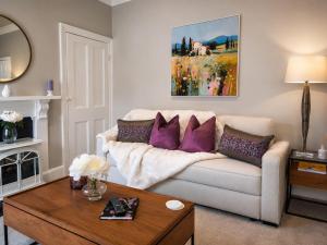 a living room with a couch and a table at Lucy's Lodge- Most Stylish Apartment On Vibrant Bishy Road with Free Parking in York