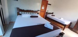 a bedroom with two beds in a room at Hotel Las Golondrinas in Puerto Berrío +10 photos