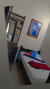 a bedroom with a bed and a mirror on the wall at Hotel Las Golondrinas in Puerto Berrío