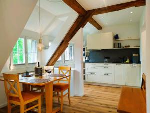 a kitchen with a table and chairs in a room at Insel-Hof Reichenau Hotel-garni in Reichenau